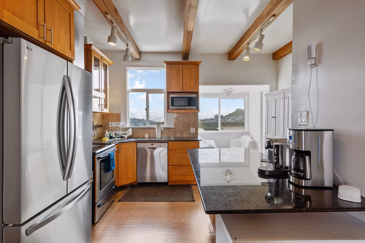 Kitchen with stainless steel appliances and breakfast nook with Bay views